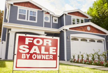 home with for sale sign in the yard