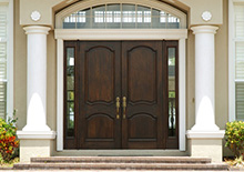 Dark coated wood double door entryway