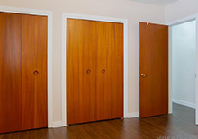 Matching wooden closet doors and bedroom door