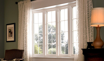4 rectangular white windows with curtains